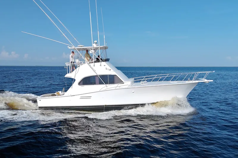 Slide: The Image of 1990 Post 44 Sport Fisherman yacht cruising on open water under clear blue sky. - 9