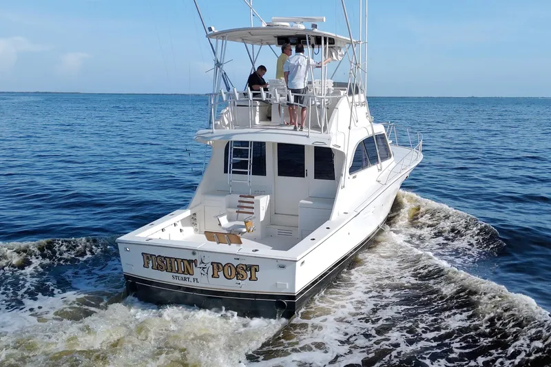Slide: The Image of 1990 Post 44 Sport Fisherman boat cruising on open water, rear view. - 10