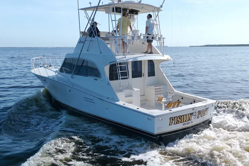 Slide: The Image of 1990 Post 44 Sport Fisherman boat cruising on open water with people onboard. - 11