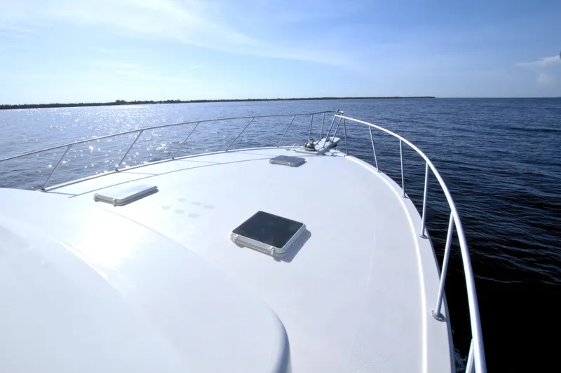 Slide: The Image of 1990 Post 44 Sport Fisherman boat on open water under clear blue sky. - 26