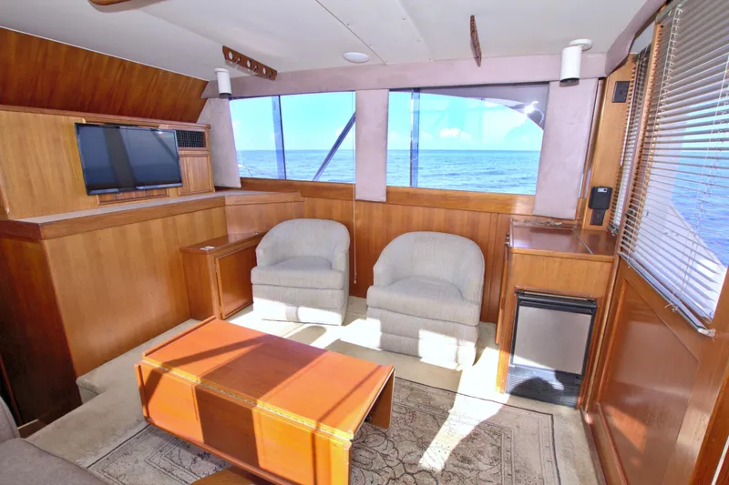 Slide: The Image of Interior of 1990 Post 44 Sport Fisherman yacht with ocean view, cozy seating, and wooden decor. - 35