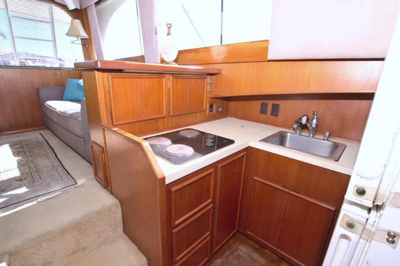 Slide: The Image of 1990 Post 44 Sport Fisherman yacht interior with compact kitchen and seating area. - 39