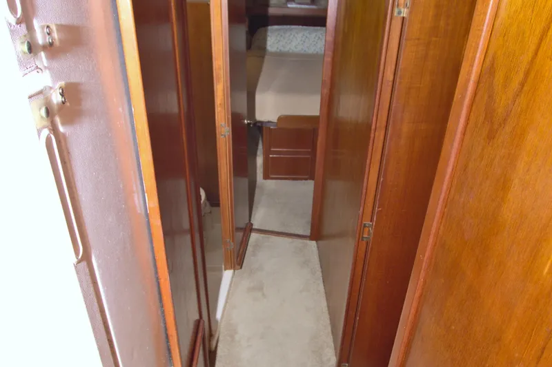 Slide: The Image of Narrow hallway inside 1990 Post 44 Sport Fisherman boat with wooden paneling. - 41