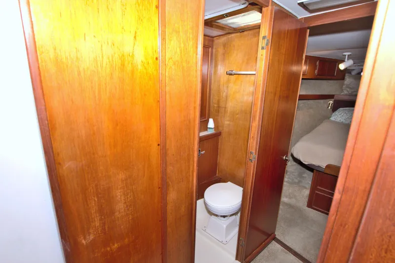 Slide: The Image of 1990 Post 44 Sport Fisherman yacht interior with wooden cabinetry and compact bathroom. - 42