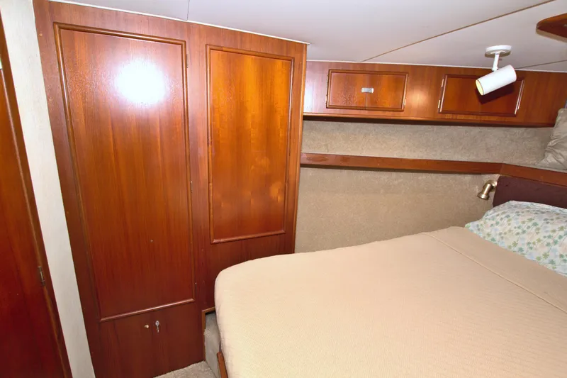 Slide: The Image of Cozy cabin interior of 1990 Post 44 Sport Fisherman with wooden cabinetry and bed. - 47