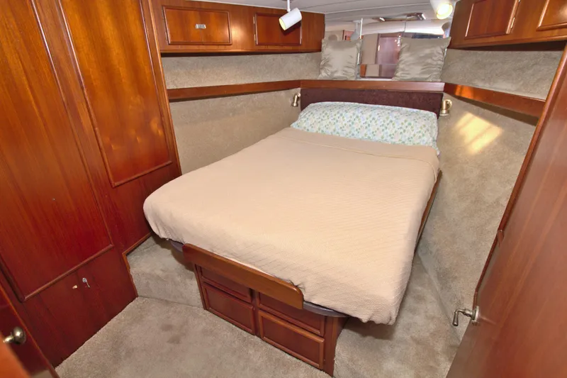 Slide: The Image of Cozy cabin interior of 1990 Post 44 Sport Fisherman with wood paneling and comfortable bedding. - 48