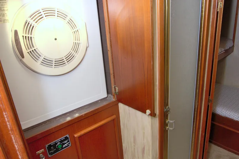Slide: The Image of 1990 Post 44 Sport Fisherman interior with dryer and wooden cabinetry. - 53