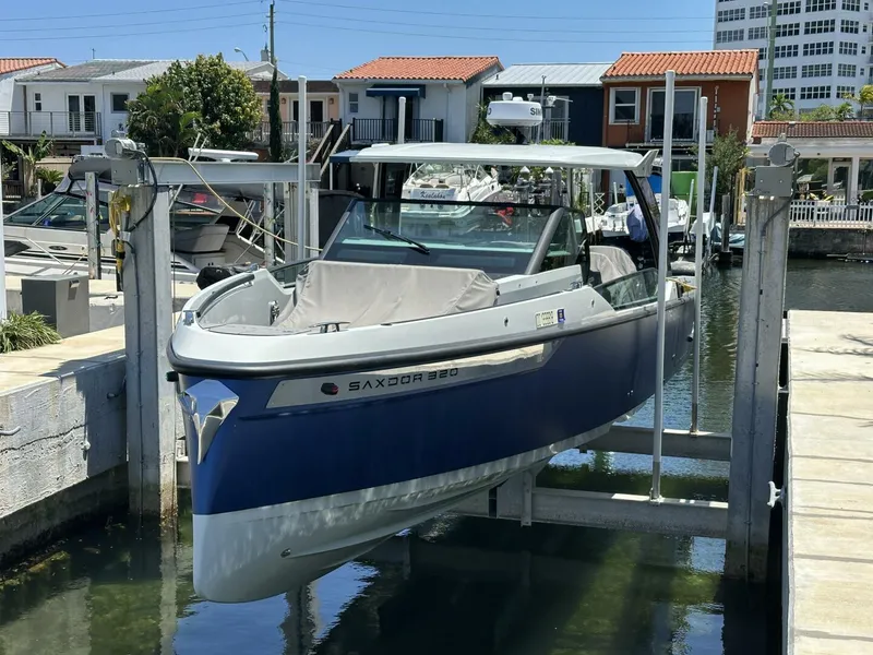 Slide: The Image of 2022 Saxdor 320 GTO boat docked in a marina, featuring sleek design and modern amenities. - 2