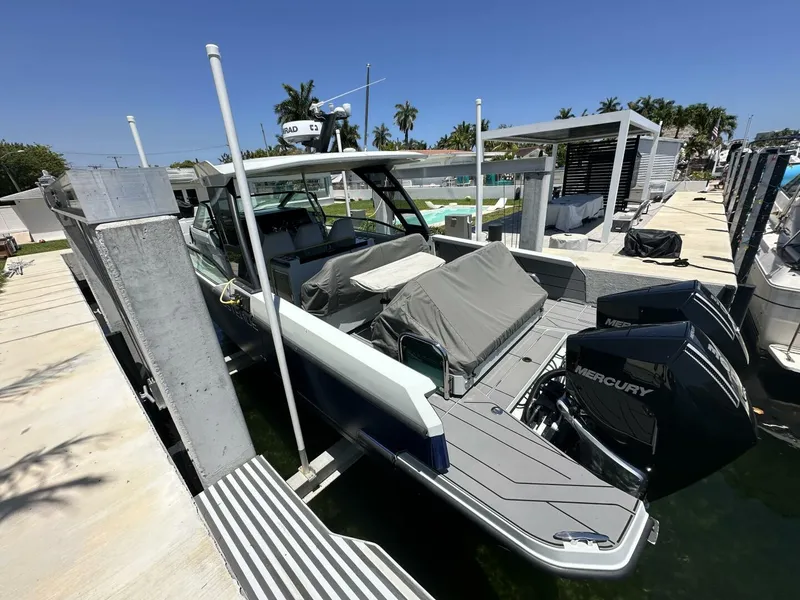 Slide: The Image of 2022 Saxdor 320 GTO boat docked with Mercury outboard engines. - 4