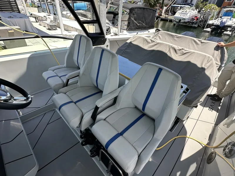 Slide: The Image of 2022 Saxdor 320 GTO boat interior with modern seating and steering wheel. - 6