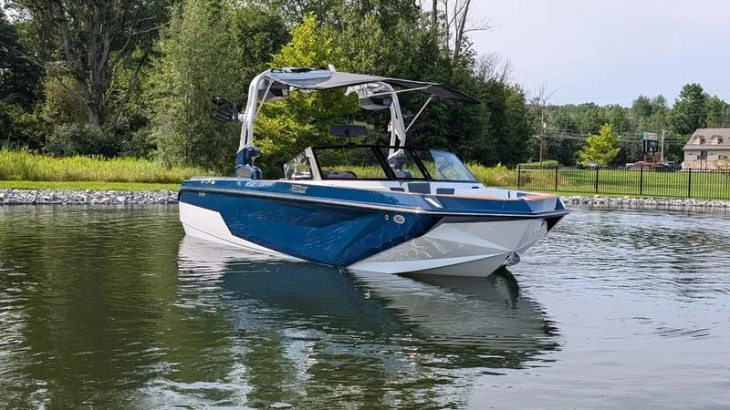 The Image of 2025 Nautique Super Air Nautique GS22 boat on a calm lake. - 1