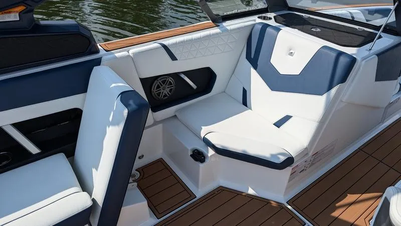 Slide: The Image of 2025 Nautique Super Air Nautique GS22 interior with stylish seating and teak flooring. - 10