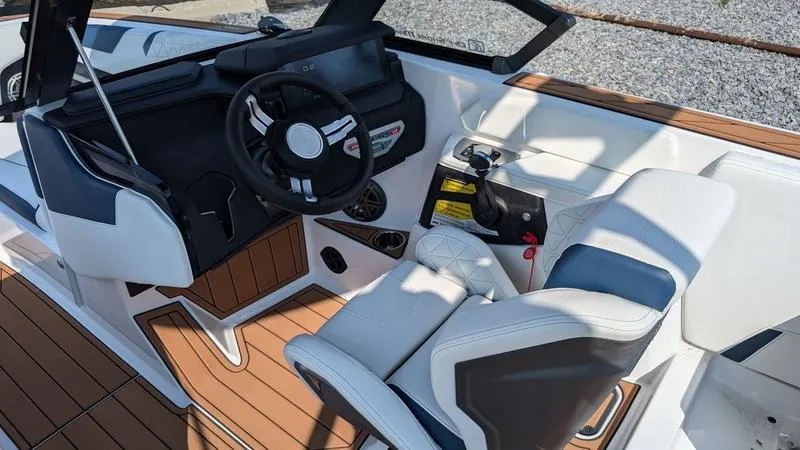 Slide: The Image of 2025 Nautique Super Air Nautique GS22 interior with modern dashboard and seating. - 11