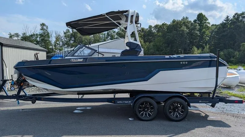 Slide: The Image of 2025 Nautique Super Air Nautique GS22 boat on trailer, parked outdoors. - 5