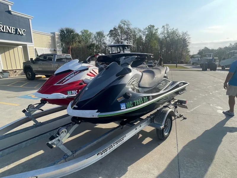 Slide: The Image of 2021 Yamaha WaveRunner GP1800R HO on trailer, parked outside a marine store. - 1