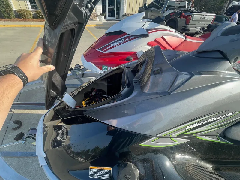 Slide: The Image of 2021 Yamaha WaveRunner GP1800R HO with open storage compartment, parked outdoors. - 10