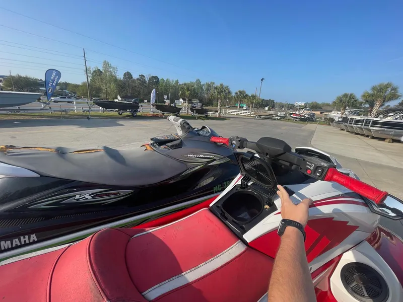 Slide: The Image of 2021 Yamaha WaveRunner GP1800R HO with red seat and handlebars in a sunny outdoor setting. - 13