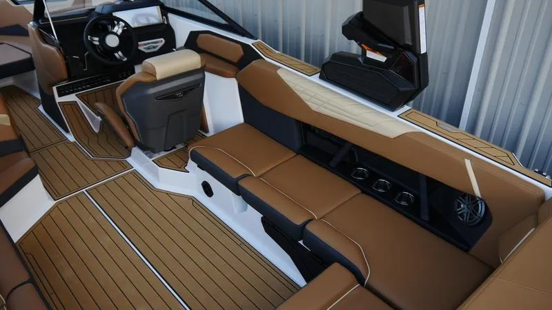 Slide: The Image of 2025 Nautique Super Air Nautique S23 interior with brown seating and modern dashboard. - 4