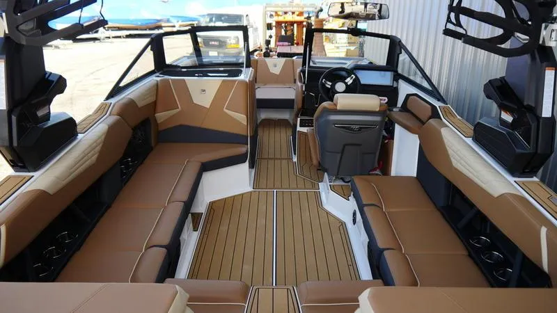 Slide: The Image of 2025 Nautique Super Air Nautique S23 interior with tan seating and modern design. - 6