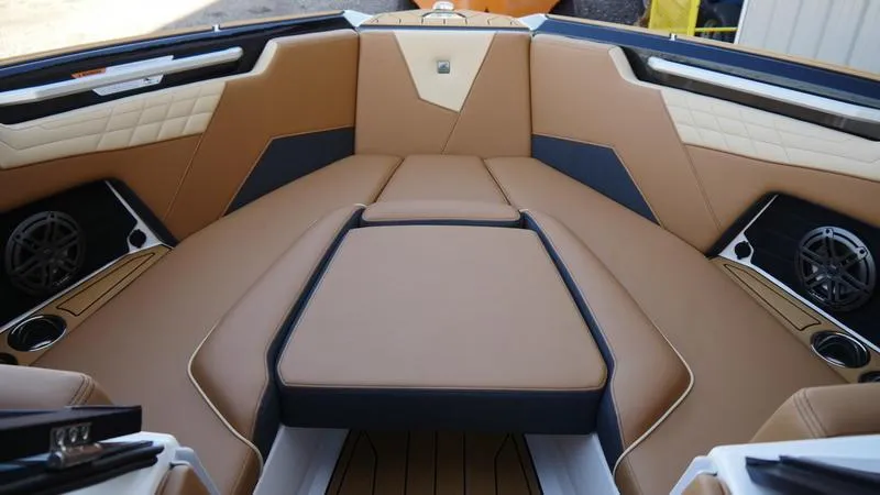 Slide: The Image of 2025 Nautique Super Air Nautique S23 interior with tan leather seating and modern design. - 7