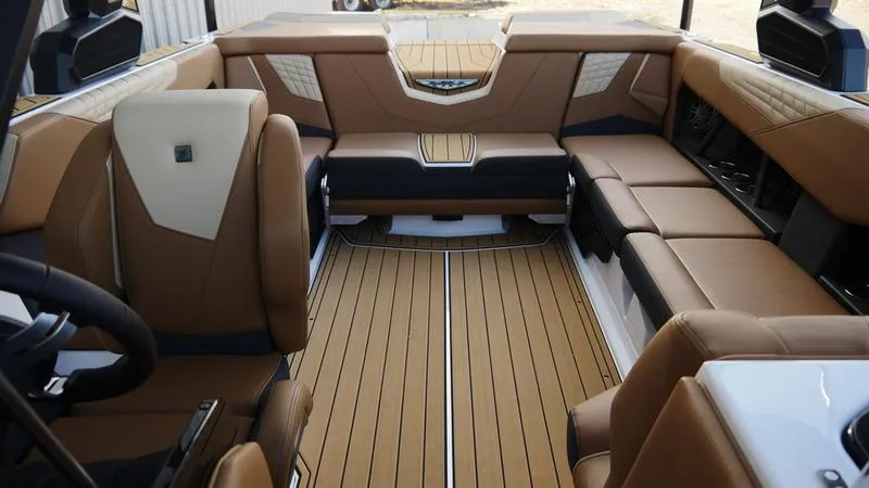 Slide: The Image of Luxurious interior of 2025 Nautique Super Air Nautique S23 boat with tan seating. - 8