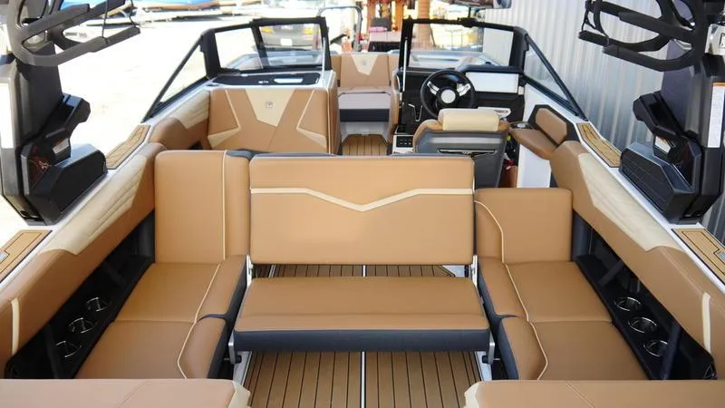 Slide: The Image of 2025 Nautique Super Air Nautique S23 interior with tan seating and modern design. - 9