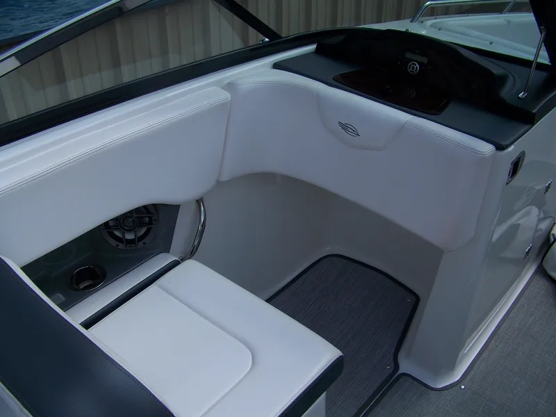 Slide: The Image of 2021 Chaparral 237 SSX boat interior with white seating and speaker detail. - 11