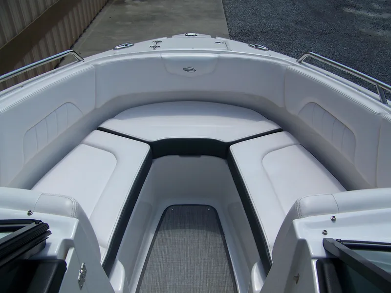 Slide: The Image of 2021 Chaparral 237 SSX boat interior with white cushioned seating and sleek design. - 12