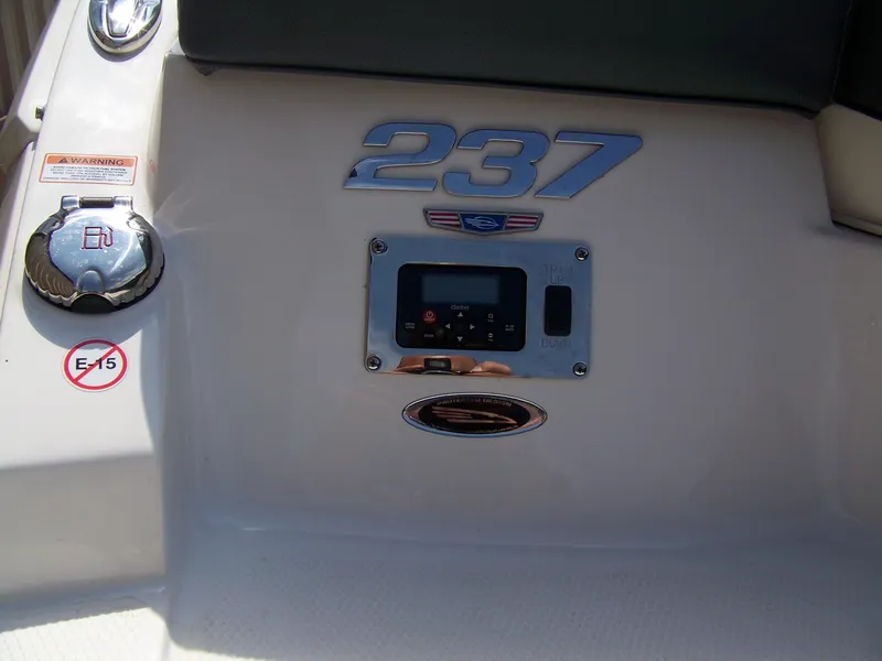 Slide: The Image of 2021 Chaparral 237 SSX boat dashboard with control panel and warning labels. - 5