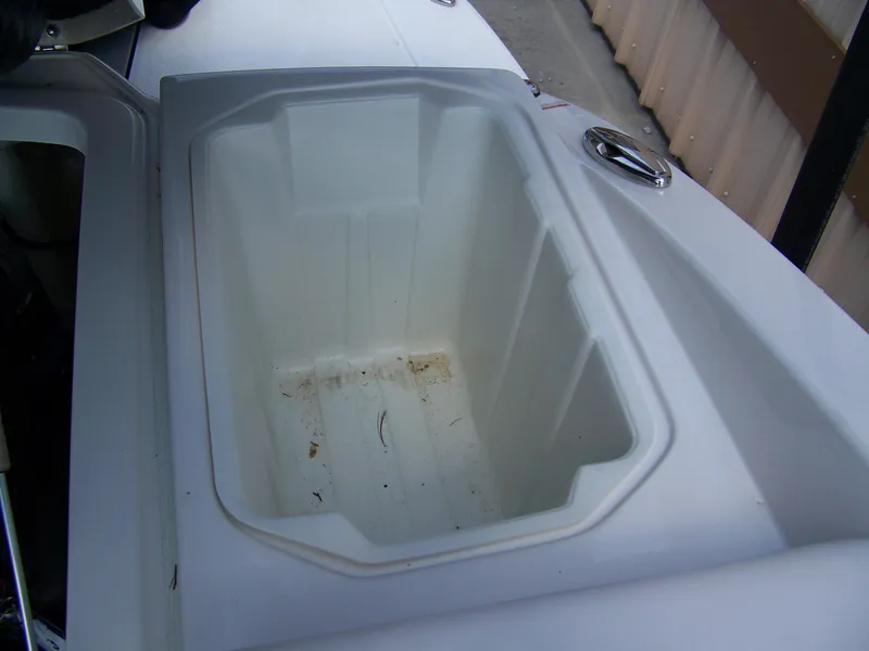 Slide: The Image of Storage compartment on a 2021 Chaparral 237 SSX boat, open and empty. - 8