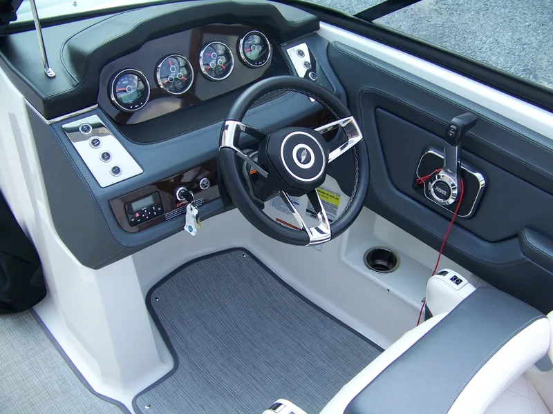 Slide: The Image of 2021 Chaparral 237 SSX boat dashboard with steering wheel and control panel. - 9