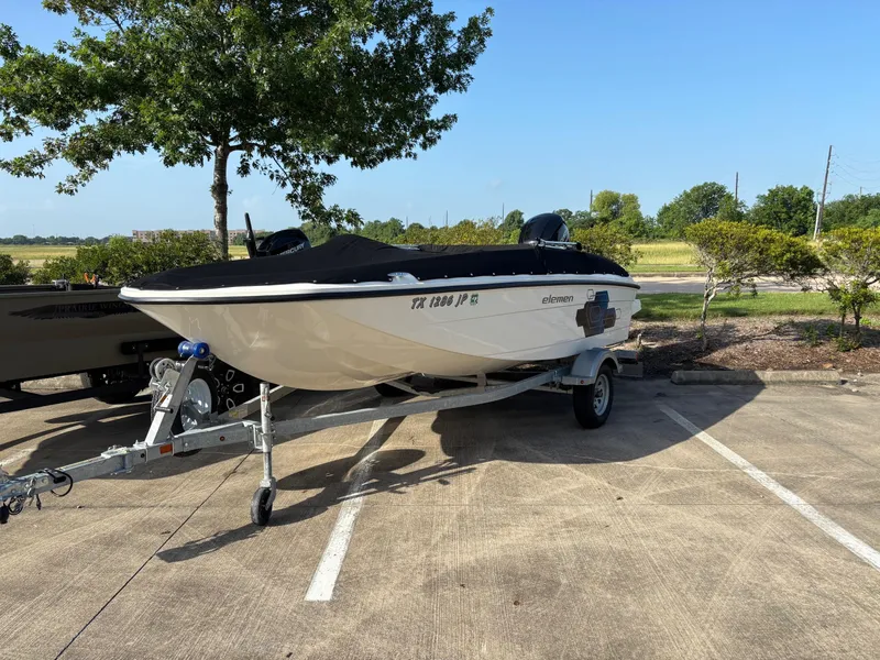 Slide: The Image of 2021 Bayliner Element E16 boat on trailer in parking lot, sunny day. - 3