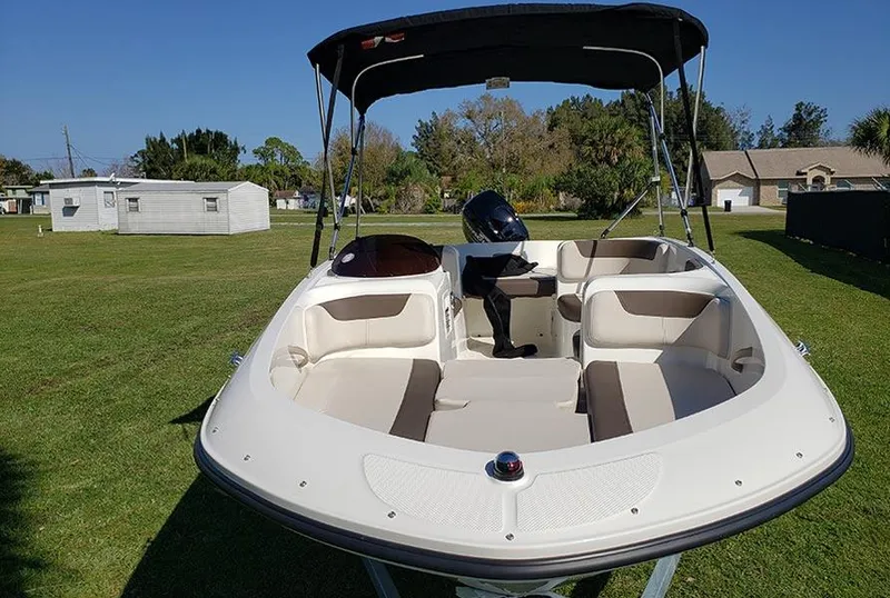Slide: The Image of 2021 Bayliner Element E16 boat with canopy on grassy area. - 4
