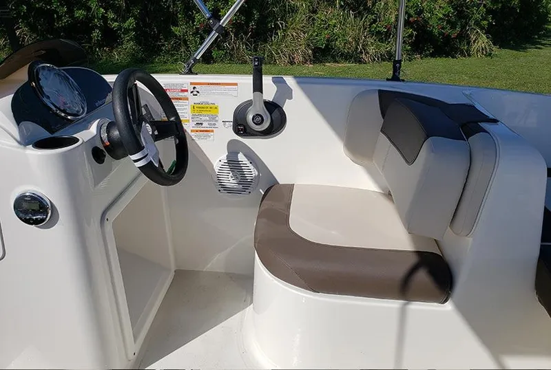 Slide: The Image of 2021 Bayliner Element E16 boat interior with steering wheel and cushioned seating. - 5