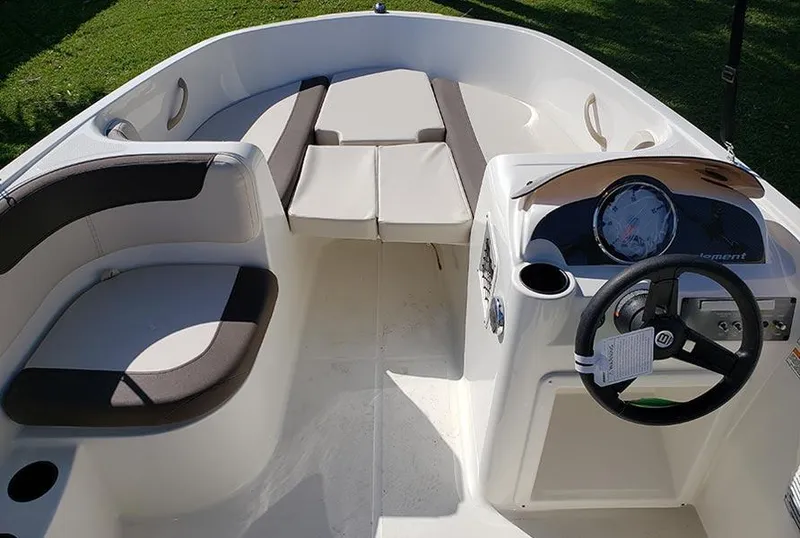 Slide: The Image of 2021 Bayliner Element E16 boat interior with seating and steering wheel. - 6