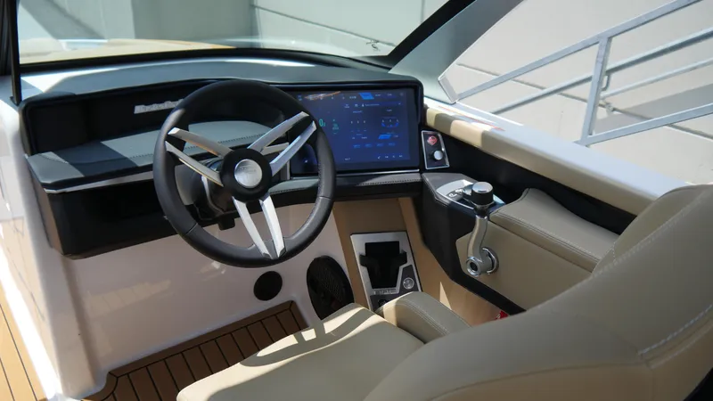 Slide: The Image of 2025 MasterCraft XT23 boat cockpit with modern steering and digital display. - 10