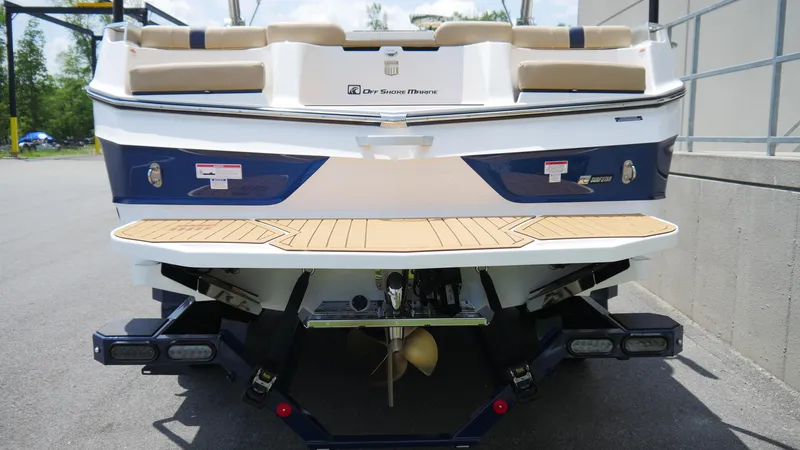 Slide: The Image of 2025 MasterCraft XT23 boat rear view with swim platform and seating. - 6