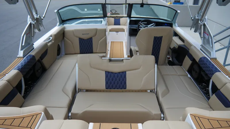 Slide: The Image of Luxurious interior of 2025 MasterCraft XT23 boat with beige and blue seating. - 8