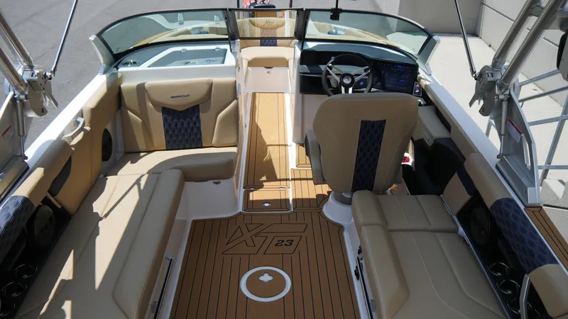 Slide: The Image of 2025 MasterCraft XT23 boat interior with luxurious seating and modern dashboard. - 9