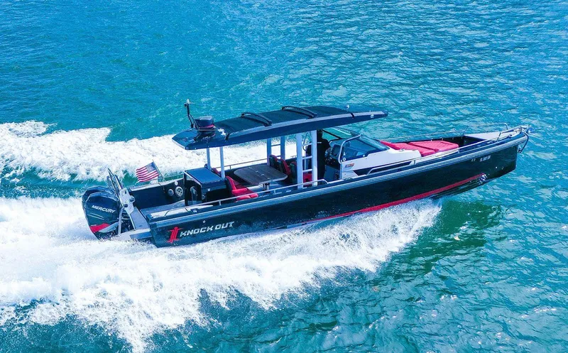 Slide: The Image of 2018 Axopar 37 Sun-Top cruising on clear blue water. - 1