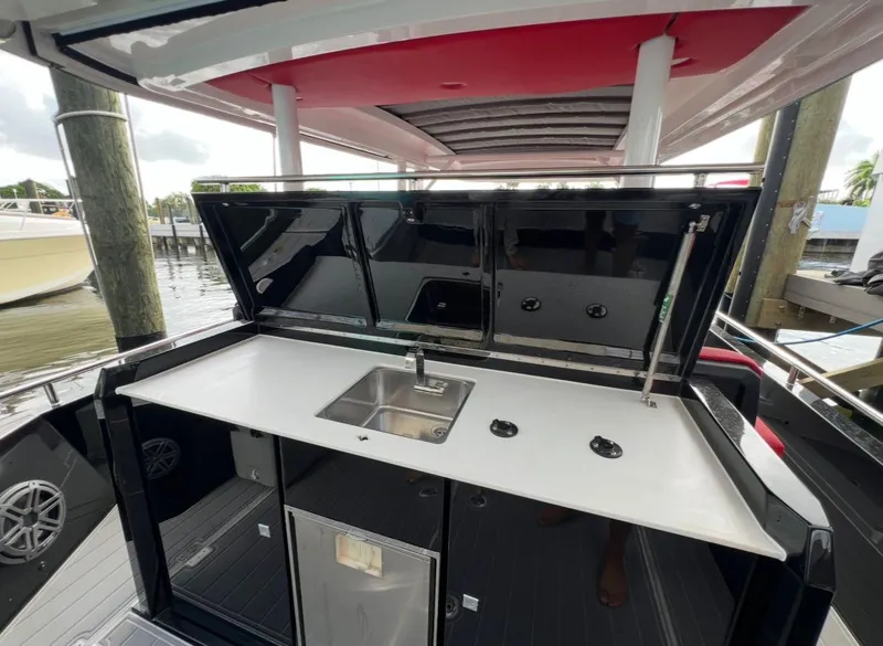Slide: The Image of 2018 Axopar 37 Sun-Top boat with outdoor kitchenette and sink. - 6