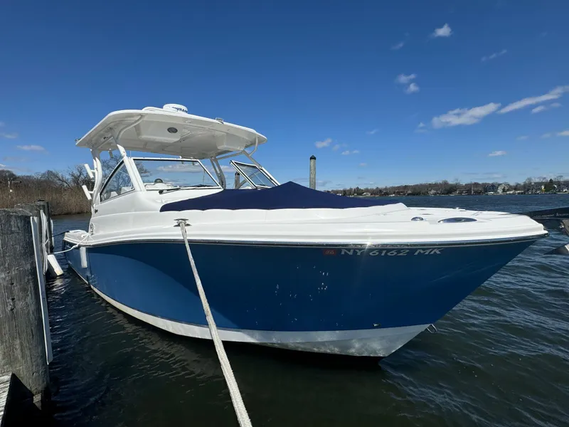 The Image of 2014 Edgewater 280 CX boat docked on a sunny day with clear skies. - 0