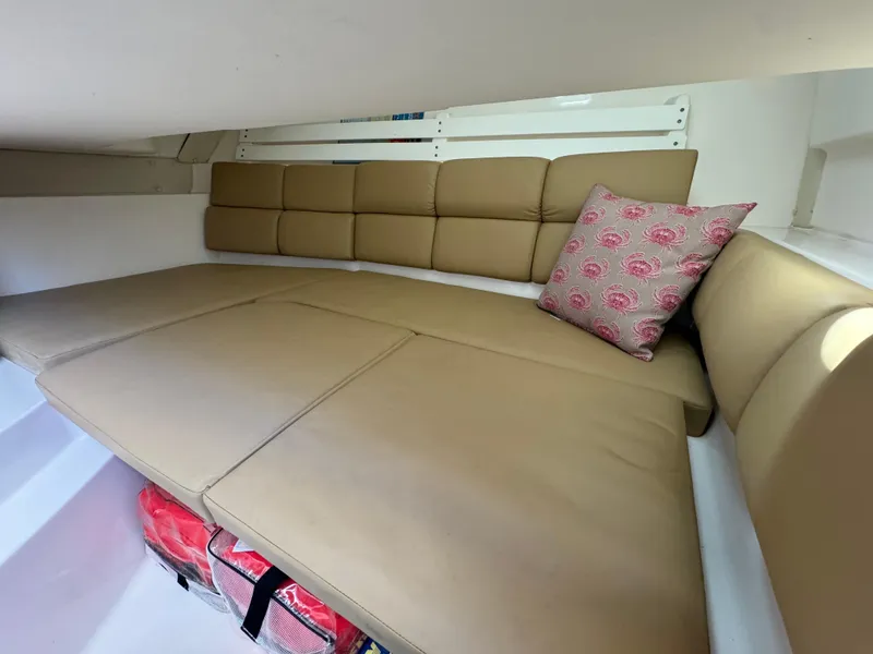 Slide: The Image of Cozy cabin interior of 2014 Edgewater 280 CX with beige cushions and decorative pillow. - 10