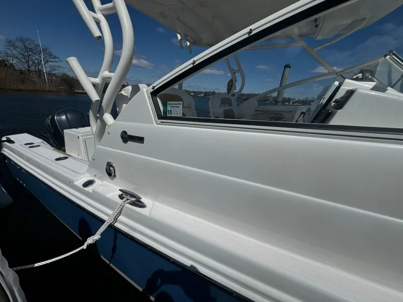 Slide: The Image of 2014 Edgewater 280 CX boat docked, showcasing sleek design and white exterior. - 3