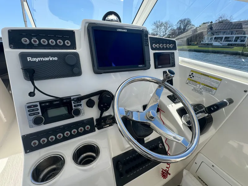 Slide: The Image of Helm of 2014 Edgewater 280 CX boat with navigation and control systems. - 9