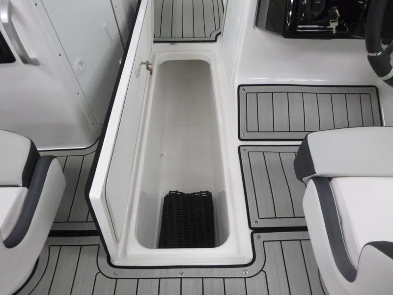 Slide: The Image of 2025 Yamaha Boats 195S interior storage compartment with sleek seating and flooring design. - 13