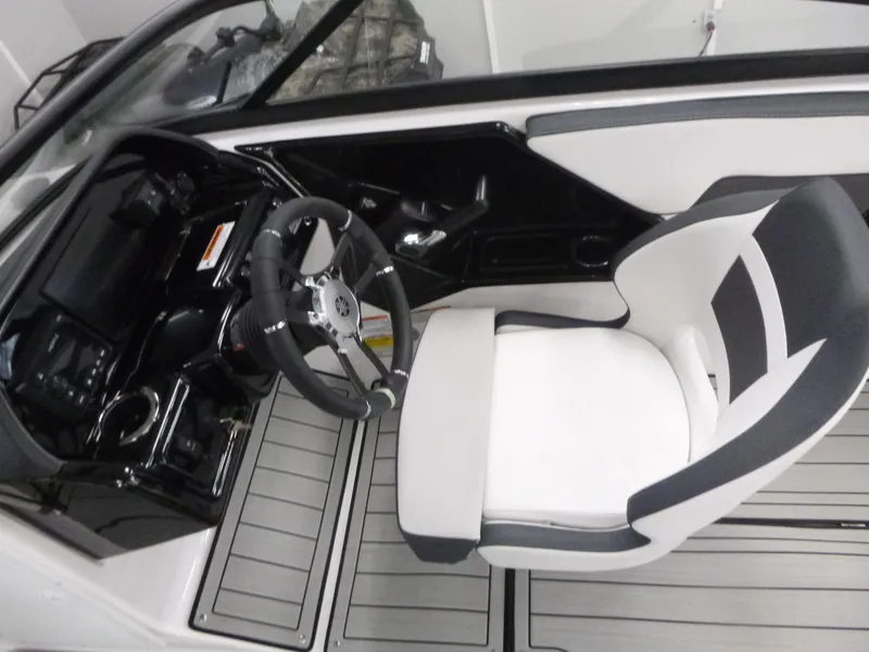 Slide: The Image of 2025 Yamaha Boats 195S cockpit with steering wheel and captain's chair. - 7