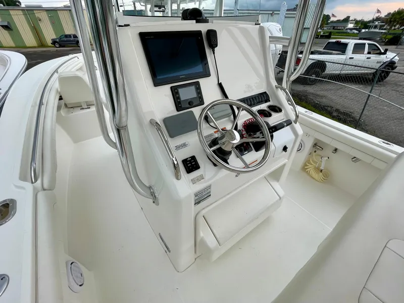 Slide: The Image of 2019 Regulator 23 boat console with steering wheel, navigation screen, and controls. - 15