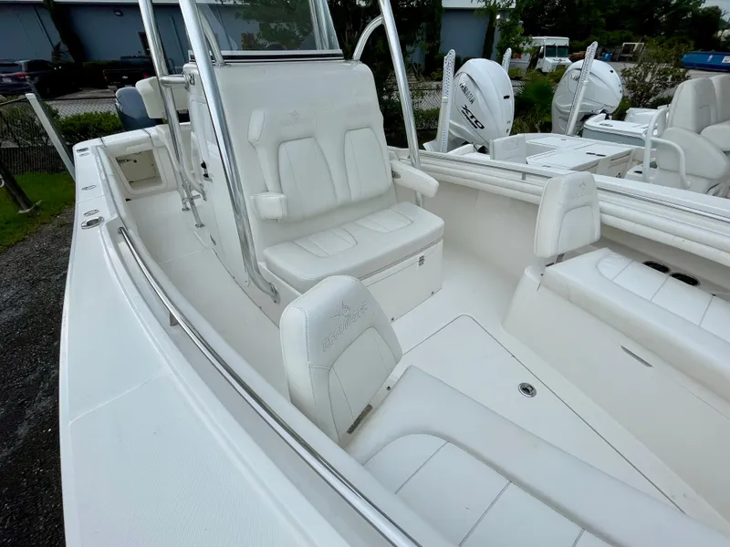 Slide: The Image of 2019 Regulator 23 boat interior with white seating and console, featuring dual Yamaha engines. - 17