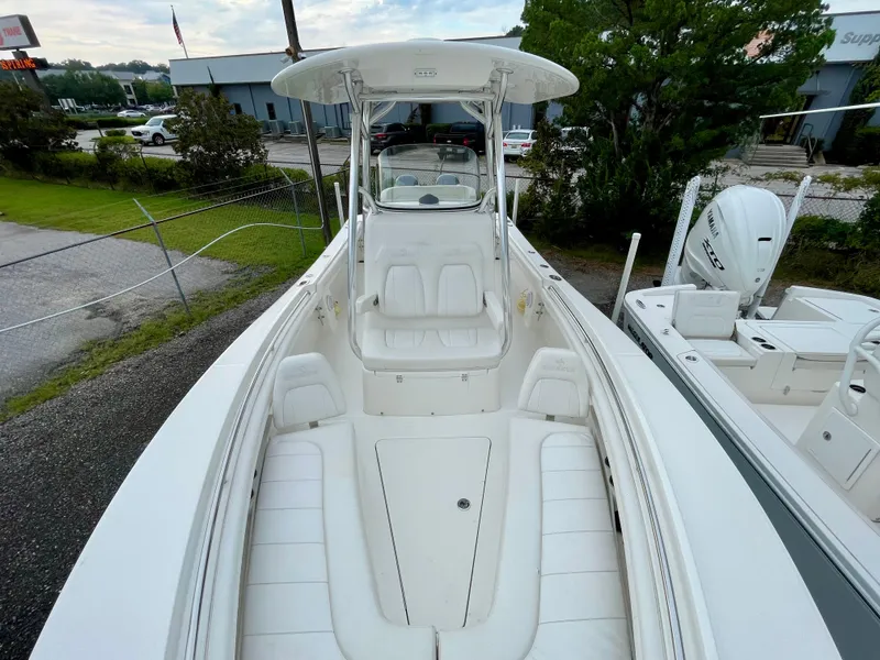 Slide: The Image of 2019 Regulator 23 boat with spacious seating and sleek design, docked outdoors. - 18